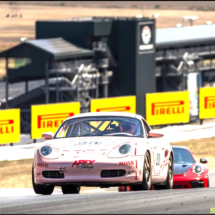 #23 leading a Porsche through a corner at Sonoma. Opens the post on Instagram.